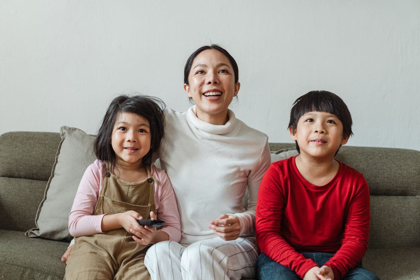 Family relaxing on a couch in a comfortable home